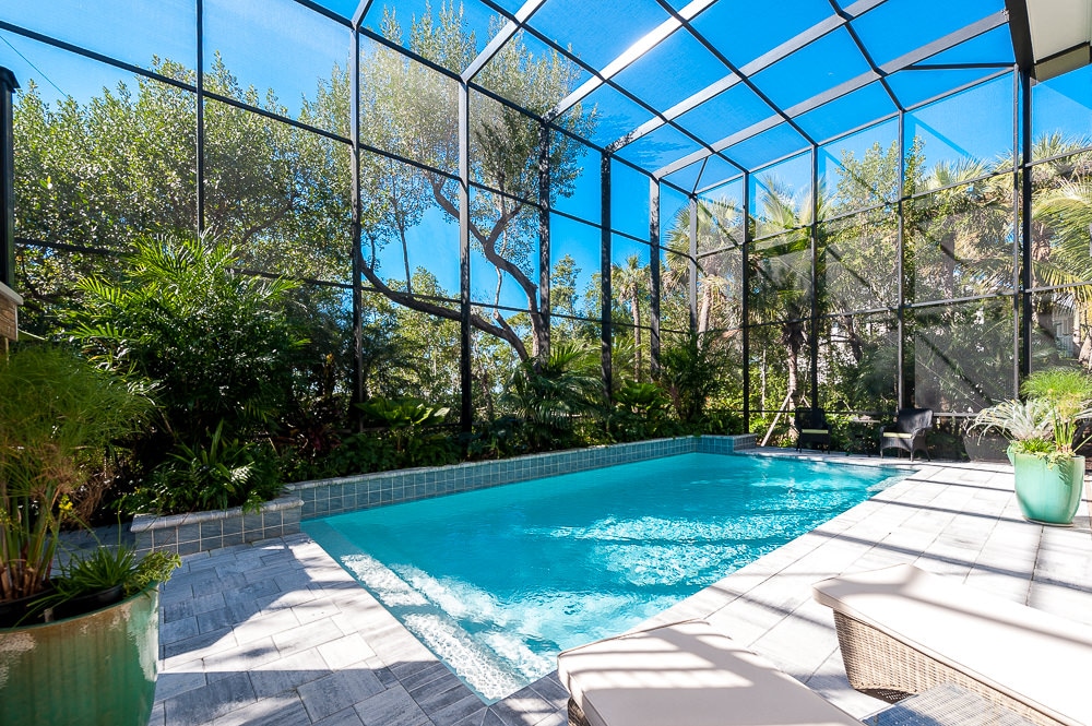 Sanibel Island home with a pool surrounded by Mangrove trees