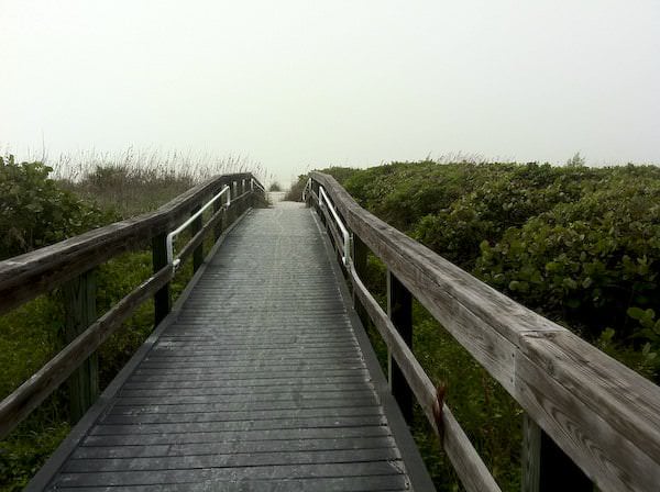 Long bridge leading to Sanibel Island beach on a foggy day