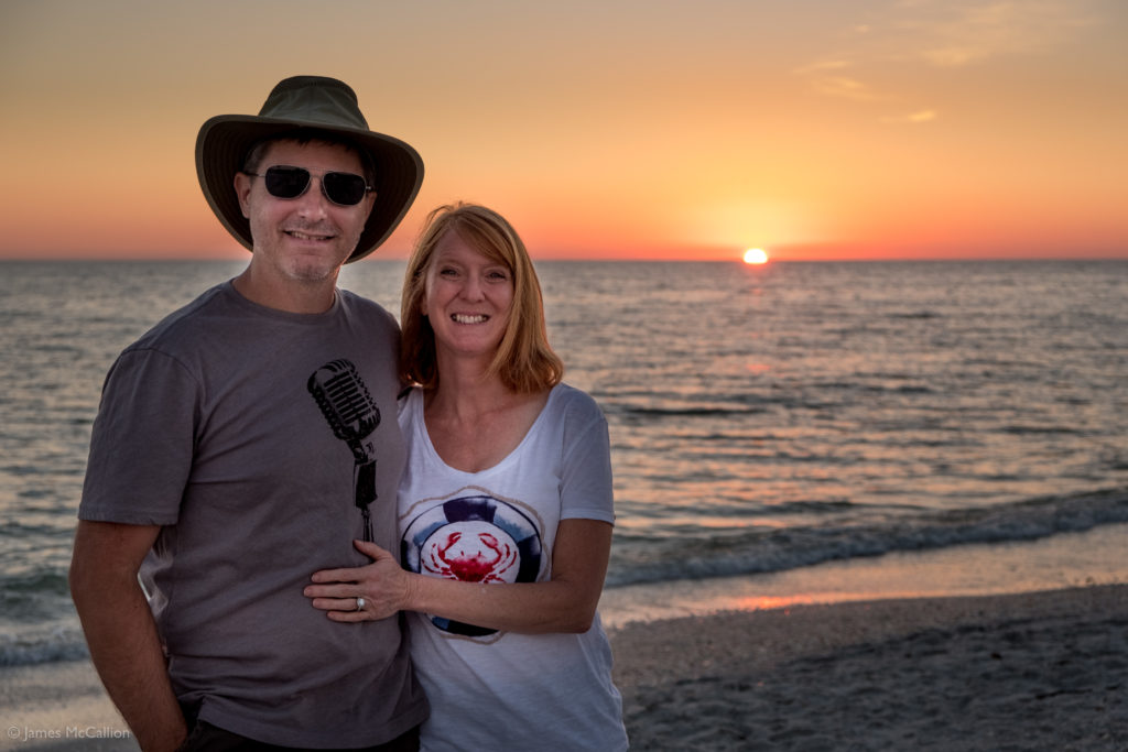 Jim and Susan McCallion in front of the sunset on the beach on Sanibel Island